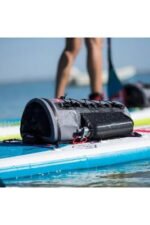 red paddle deck bag on paddle board lying down